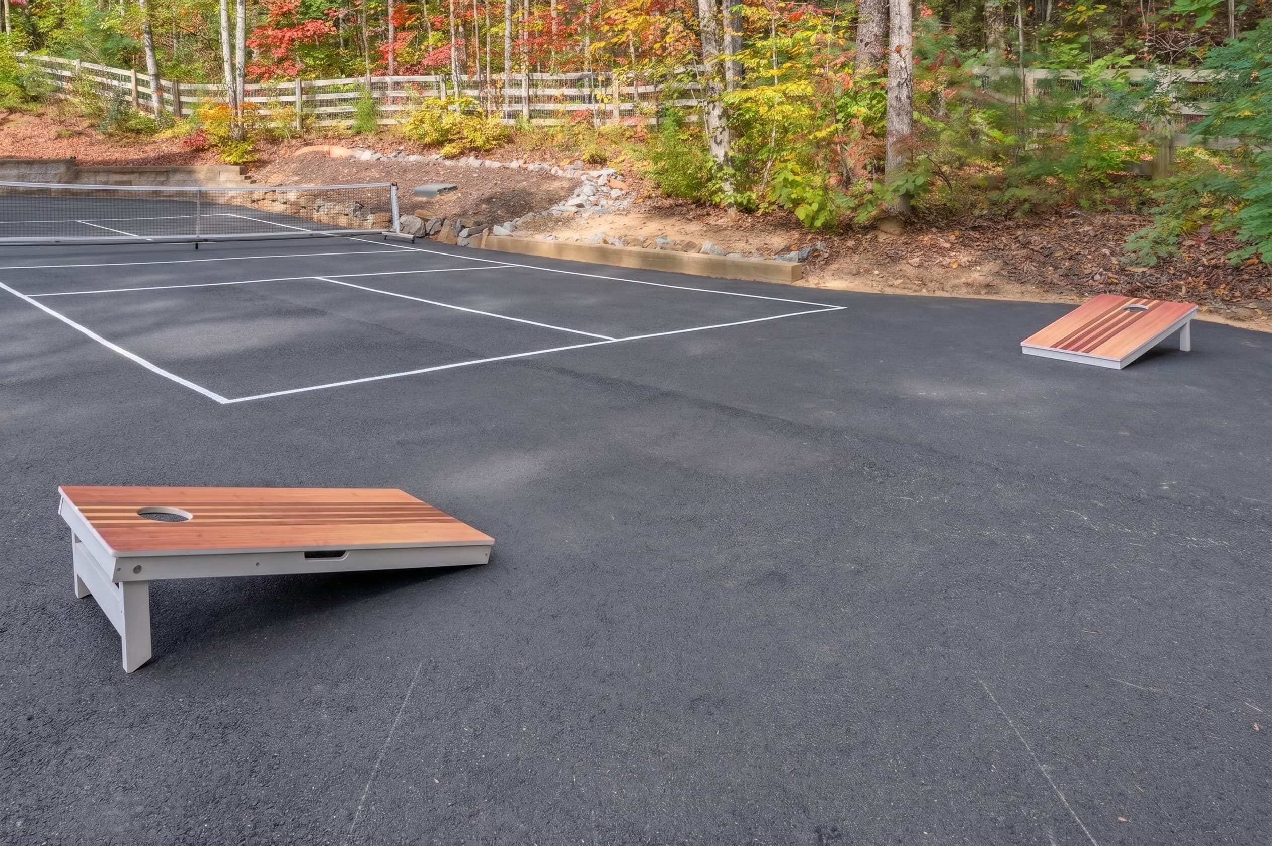 Cornhole boards beside the private pickleball court